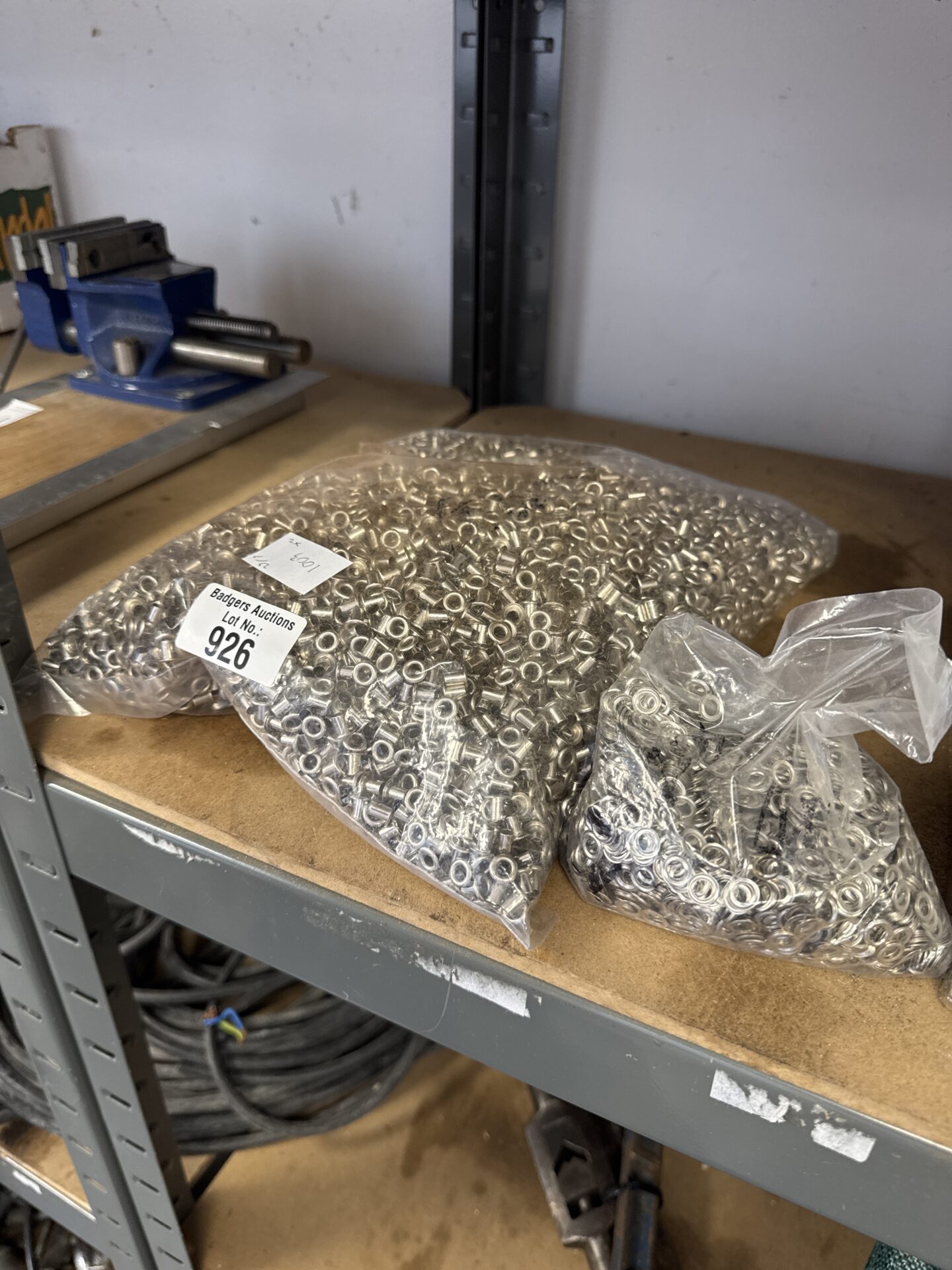 926 Two sealed bags of small fabric eyelets