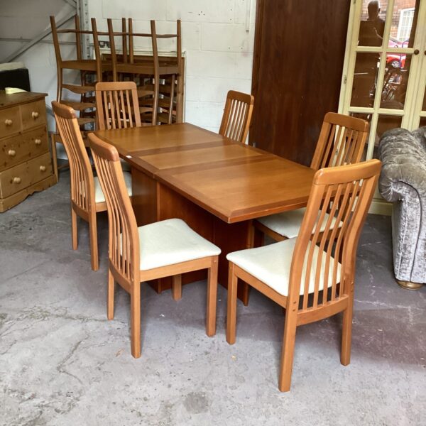 Full view of Kovby dining table and six chairs in a room.