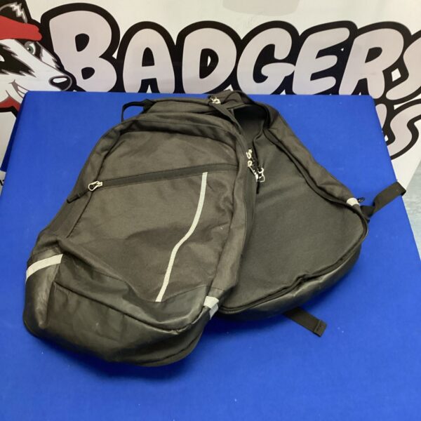 Black motorcycle panniers showing wear and tear.