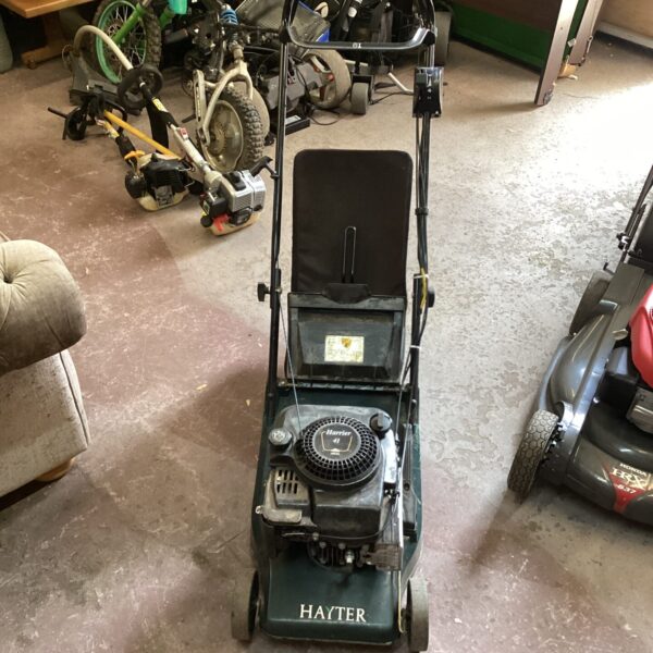 Used Hayter Harrier 41 petrol lawnmower for garden maintenance.