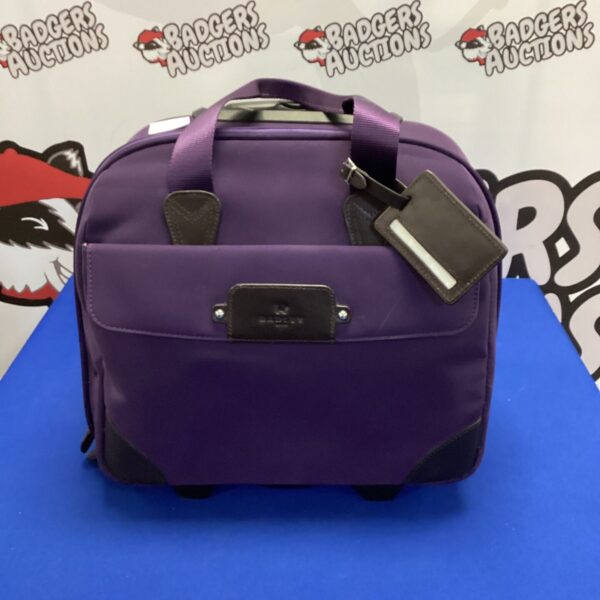 Purple Radley travel bag with wheels and extendable handle.