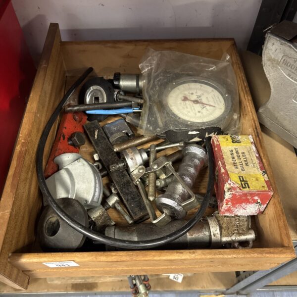 Vintage automotive tools in a drawer, classic car repair equipment.