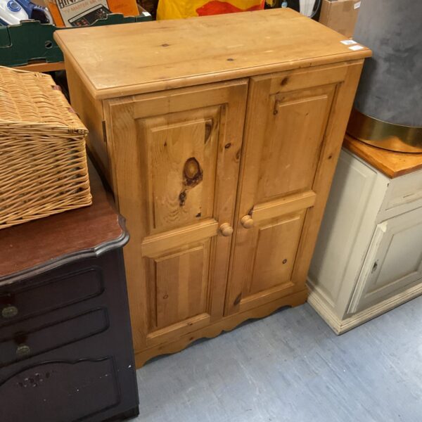 Vintage pine two door cabinet for storage and display.