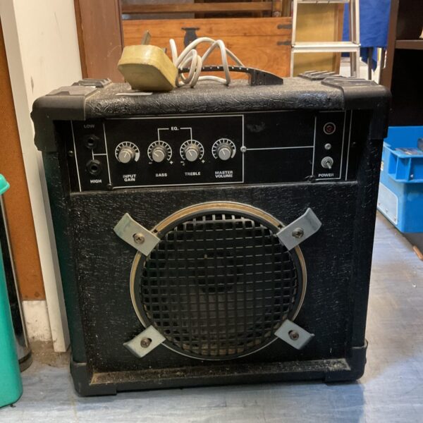 Front view of a vintage guitar amplifier with knobs and speaker.