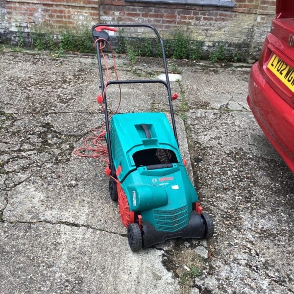 Bosch electric lawn rake in used condition, ideal for garden maintenance.