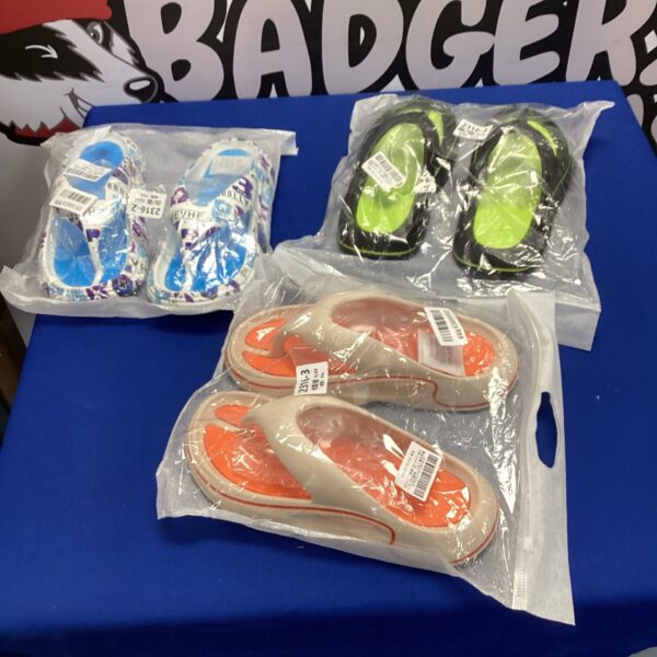 Three pairs of new mevhe flip flops in packaging.