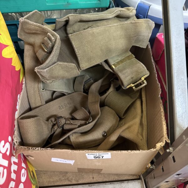 Vintage military webbing set with khaki pouches and straps.