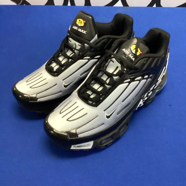 Silver Nike Air Max TN trainers size 9, athletic footwear.