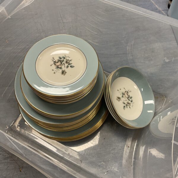 Stack of vintage Royal Doulton Rose Elegans plates with floral design.