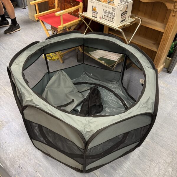 Amazon Basics small pet playpen, folded and ready for use.