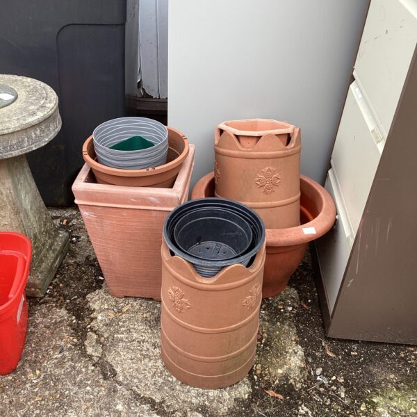 Selection of terracotta-effect plastic garden planters for outdoor use.