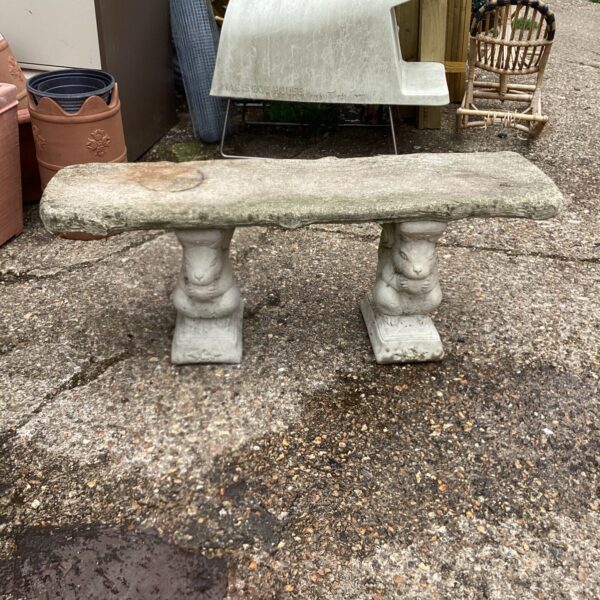Detailed stone effect garden bench with sculpted design.