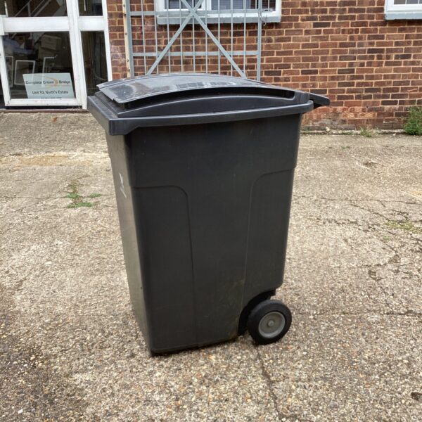 Large plastic wheelie bin for garden and outdoor refuse collection.