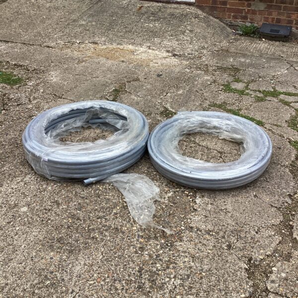 Two lengths of 22mm plastic pipe for plumbing projects.