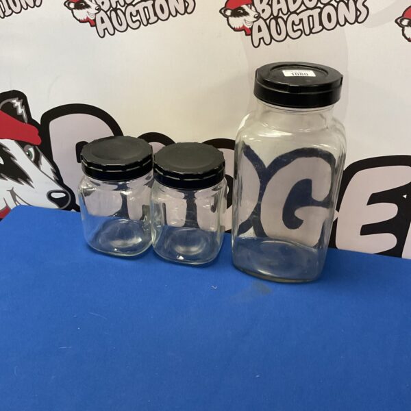 Three clear glass storage jars for kitchen organisation.