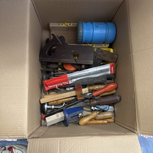 Mixed tool lot with chisels, files, and various hand tools.