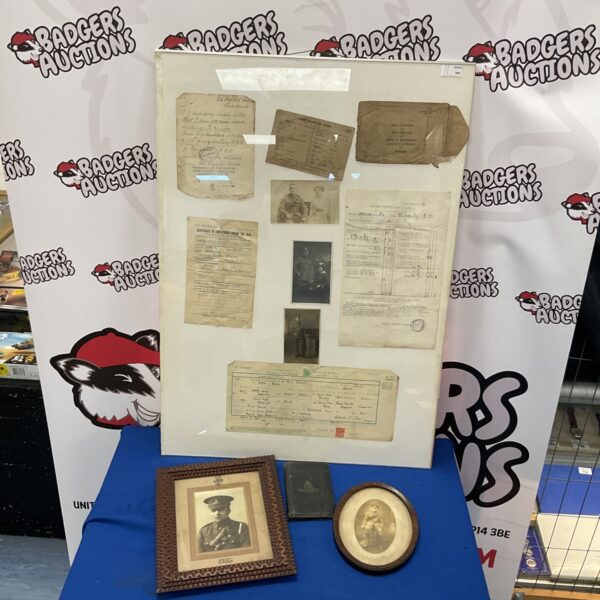 WWI ephemera collection featuring framed photographs and a soldier’s diary.