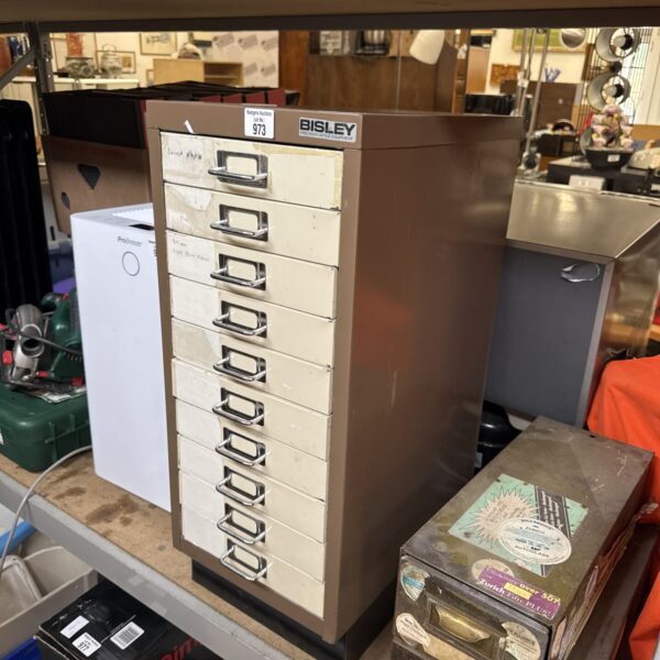 Vintage metal Bisley filing cabinet for office document storage.