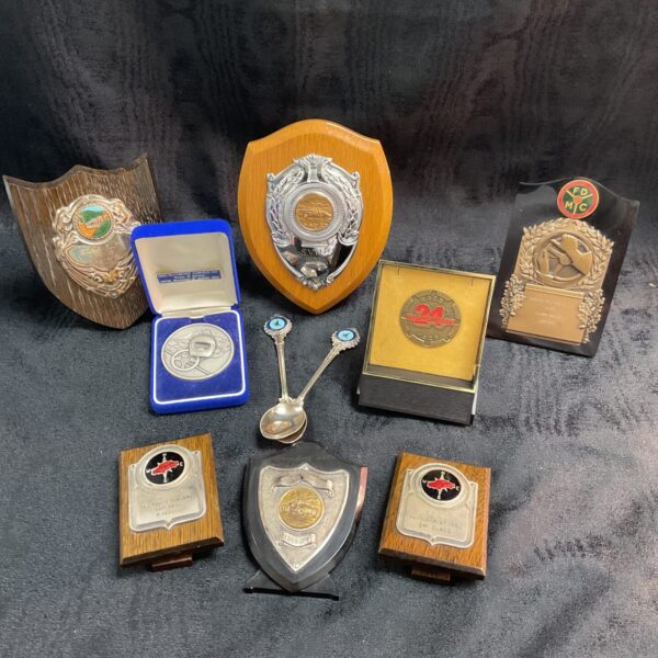 Vintage motorsport trophies and spoons collection from the 1960s.