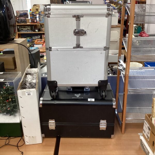 Two rolling makeup artist cases with telescopic handles.