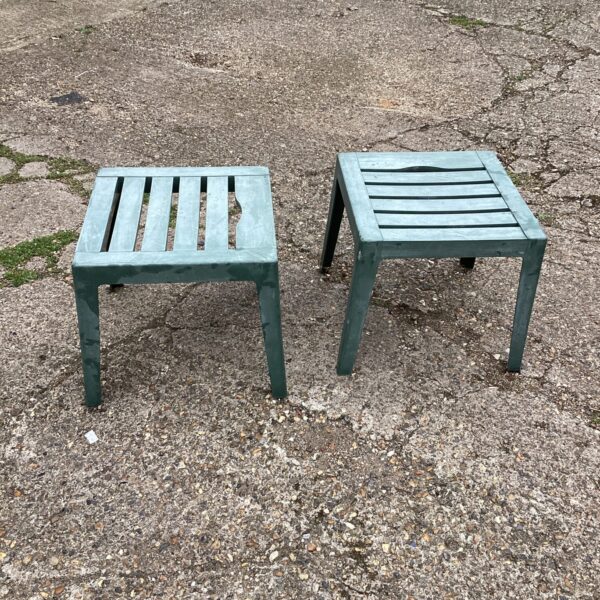 Two small metal patio tables for garden or patio use.