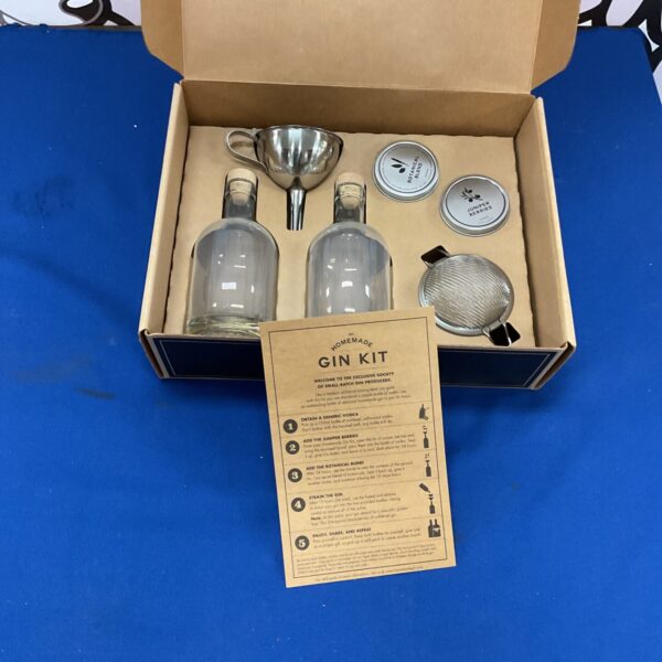Homemade gin kit with botanical ingredients and tools.