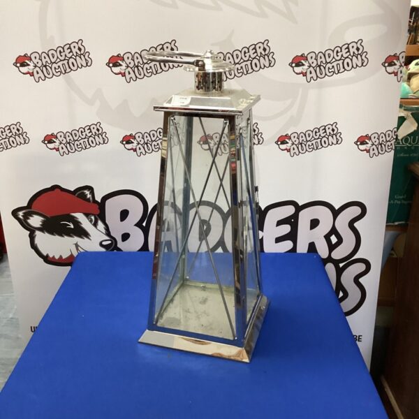 Large metal candle lantern for home decor and ambiance.