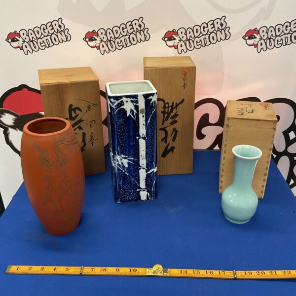 Boxed set of three signed Japanese porcelain vases.