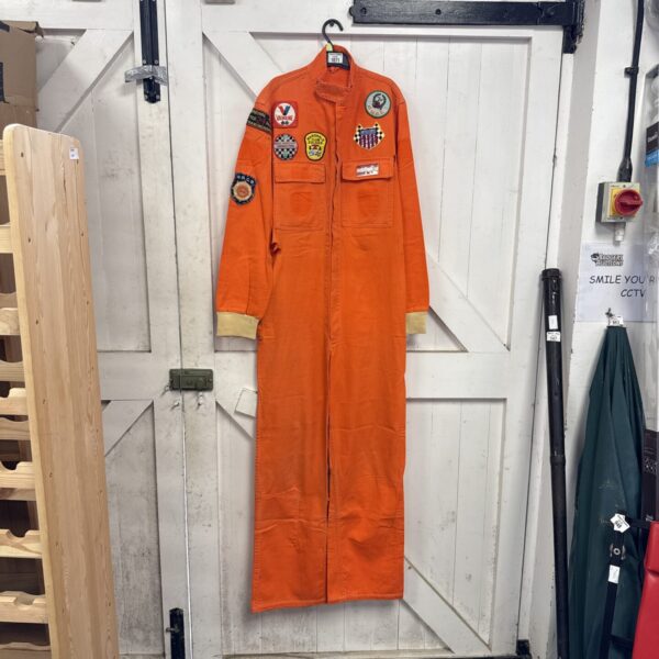 Orange race marshal overalls with Silverstone and Le Mans badges.
