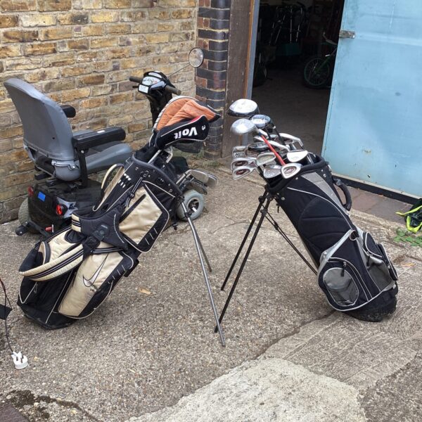 Golf stand bag with golf clubs, showing signs of use.