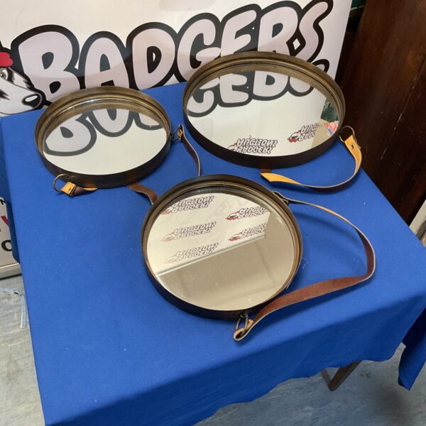 Vintage leather strap mirror with metal frame.
