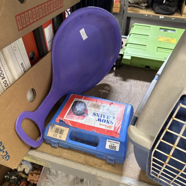 Vintage snow chains and shovel set for winter vehicle use.