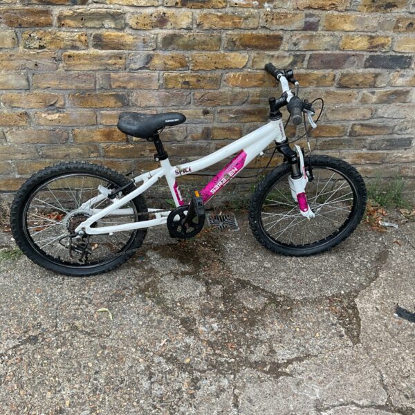 Side view of a blue and white Saracen Spice kids mountain bike.