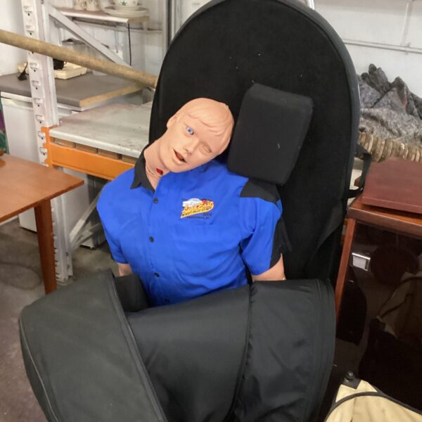 Meti emergency care simulator dummy on wheeled cart for medical training.