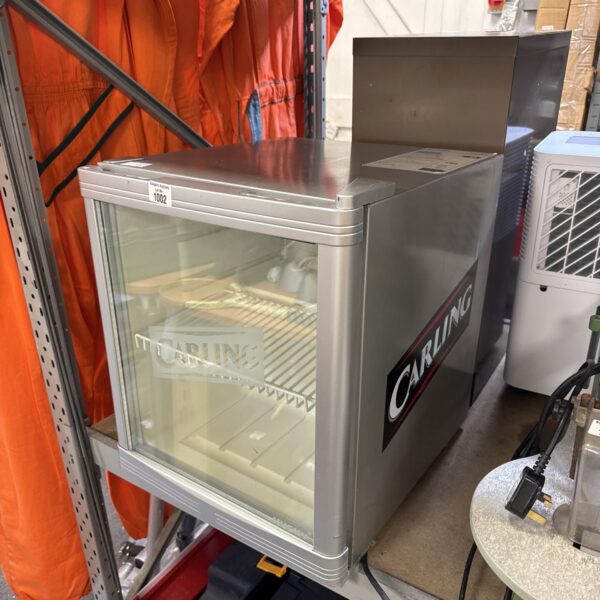 Front view of a Carling branded beer fridge in untested condition.