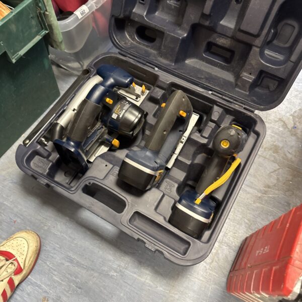 Cordless power tool set in open carrying case.