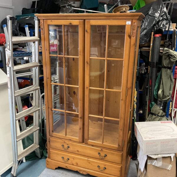 Large pine display cabinet with glass doors and drawers.
