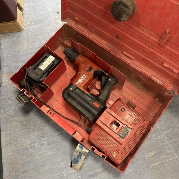 Hilti SDS drill with battery and charger in open case.