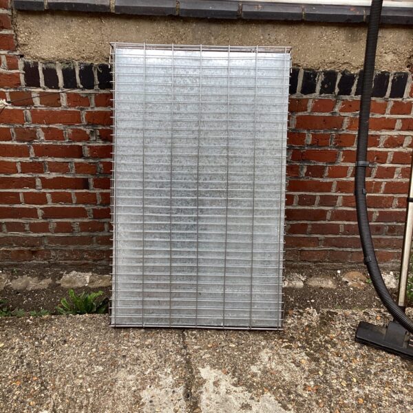 Large galvanised animal cage for livestock transport.