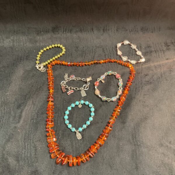 Vibrant amber bead jewellery lot with necklace and bracelets.