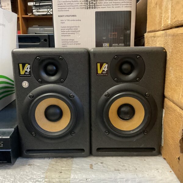 Pair of KRK Rokit 4 studio monitors in a studio setting.