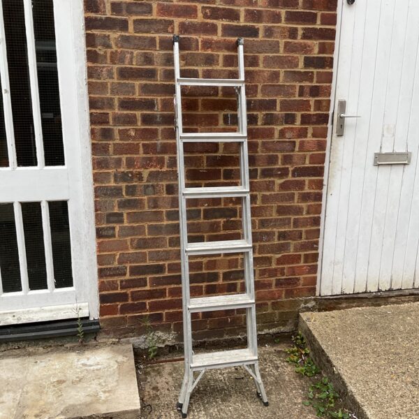 Silver Abru extending aluminium ladder leaning against a brick wall.