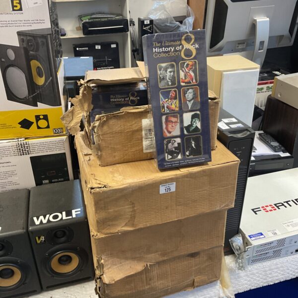 Stack of boxes containing the Ultimate History of Rock collection.