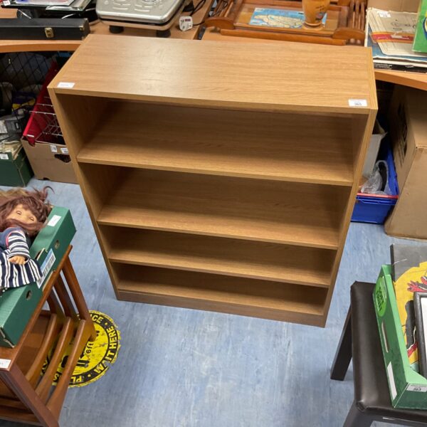Vintage oak bookshelf with three shelves, ideal for home storage.