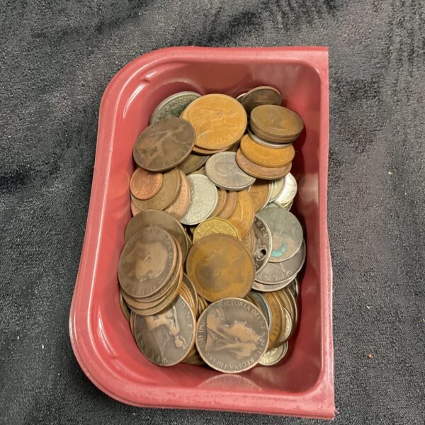 Mixed coin lot featuring vintage British pennies in a pink tub.