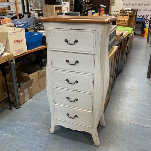 Front view of a shabby chic pine tallboy with five drawers.