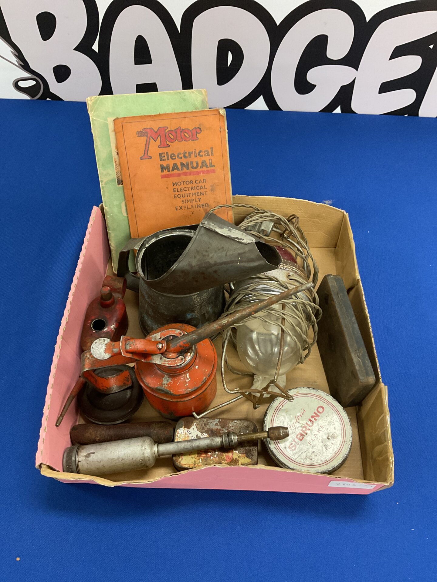 926 Collection of vintage oil cans grease gun and motor car booklets