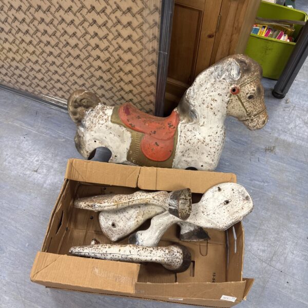 Antique ride-on horse for restoration, showing wear and tear.