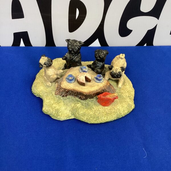 Vintage English Pug Tea Party figurine on a patterned surface.