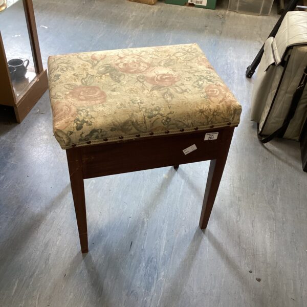 Vintage padded sewing box with floral pattern for storage.